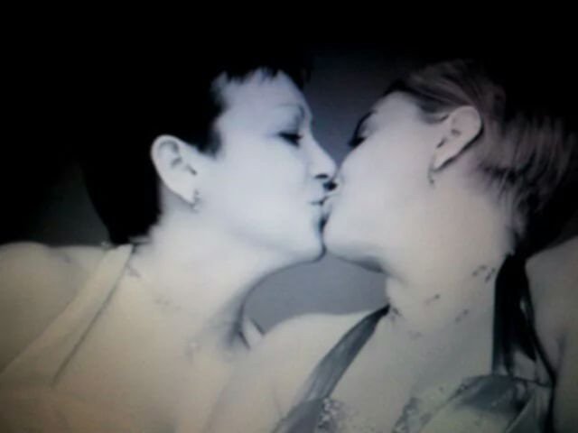 Intimate black and white moment of a couple sharing a kiss