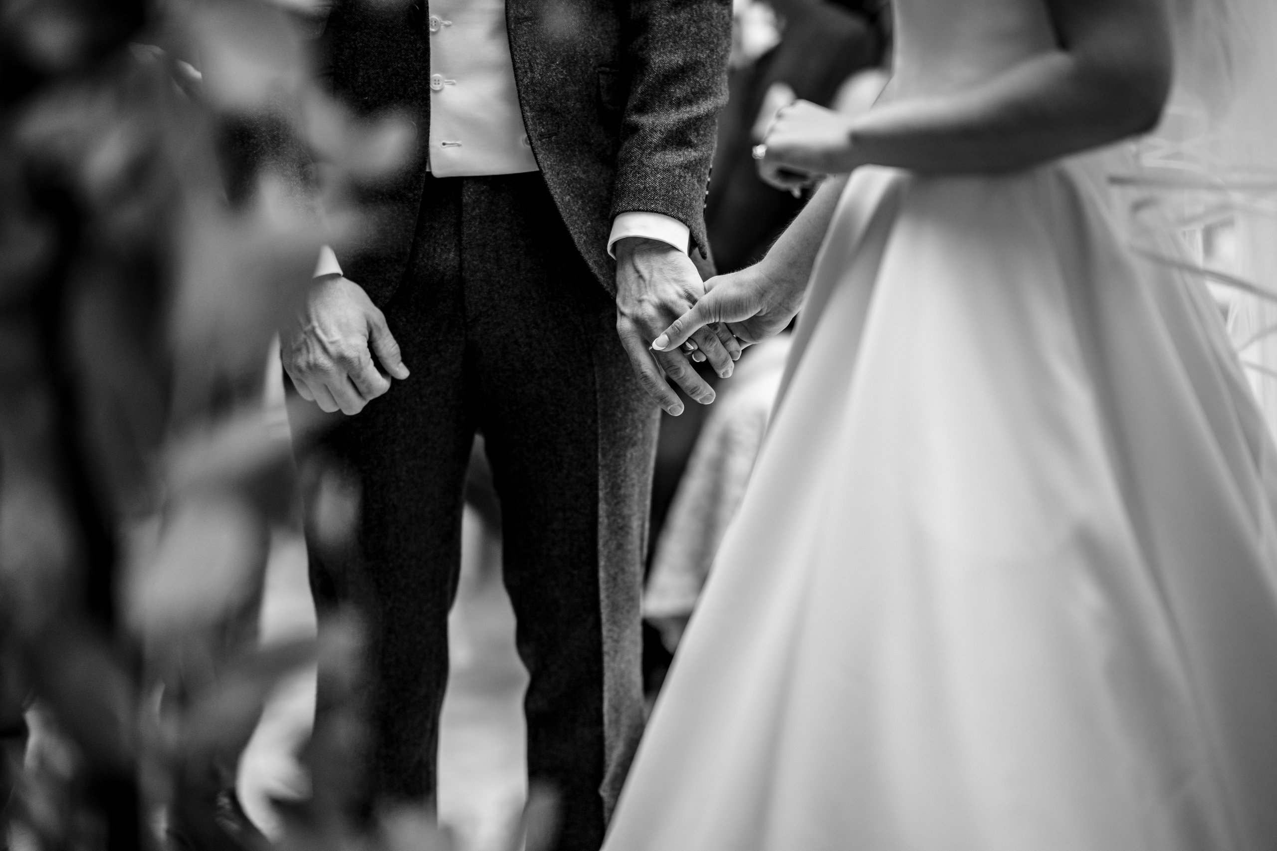 Close-up of couple holding hands during ceremony